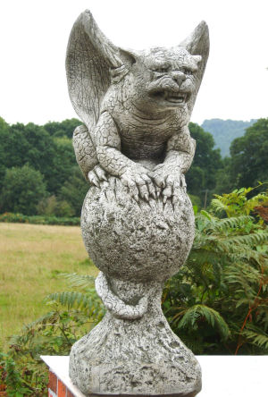 Gavin gargoyle sitting on a ball stone statue